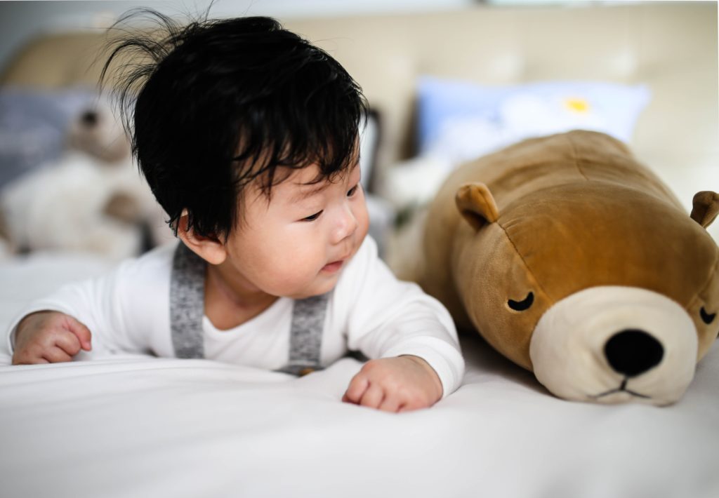 baby with stuffed animals toys