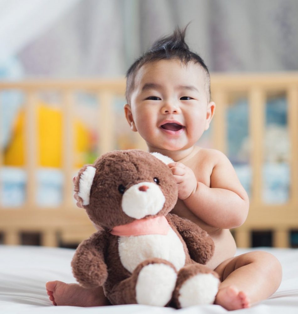 Asian baby sit with teddy bear child growth How can I support my child as they grow? baby